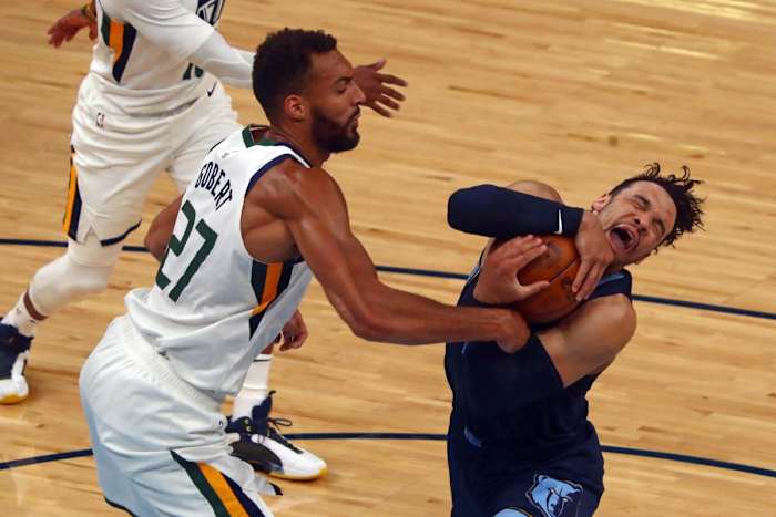 Rudy Gobert (27) tries to strip the ball from Dillon Brooks (24)